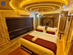 Premium houseboat with glass enclosed living area cruising through Alleppey backwaters in Kerala