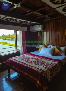 Air-conditioned bedroom with clean linens and scenic window views inside Neptune traditional houseboat MRB01