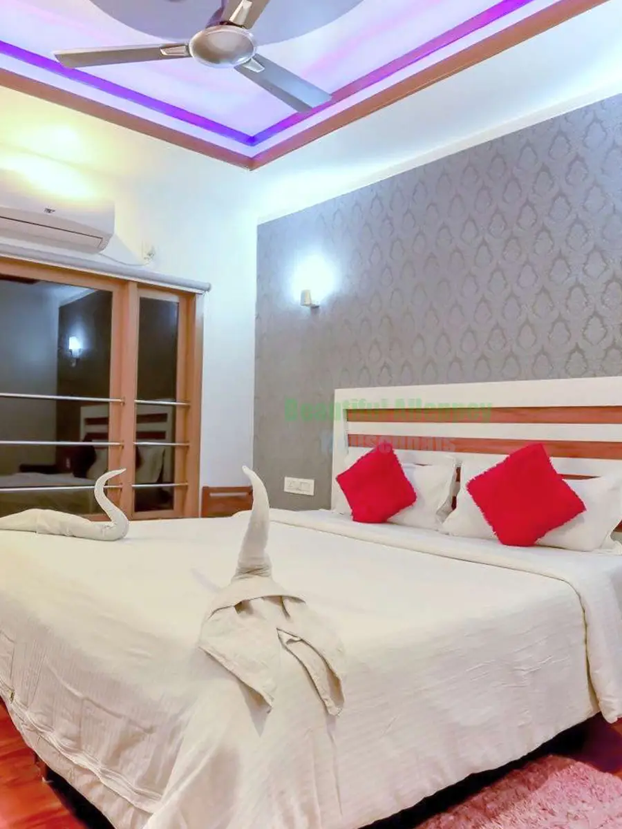 Air-conditioned bedroom with plush bedding and viewing window on Queens premium houseboat BNU01